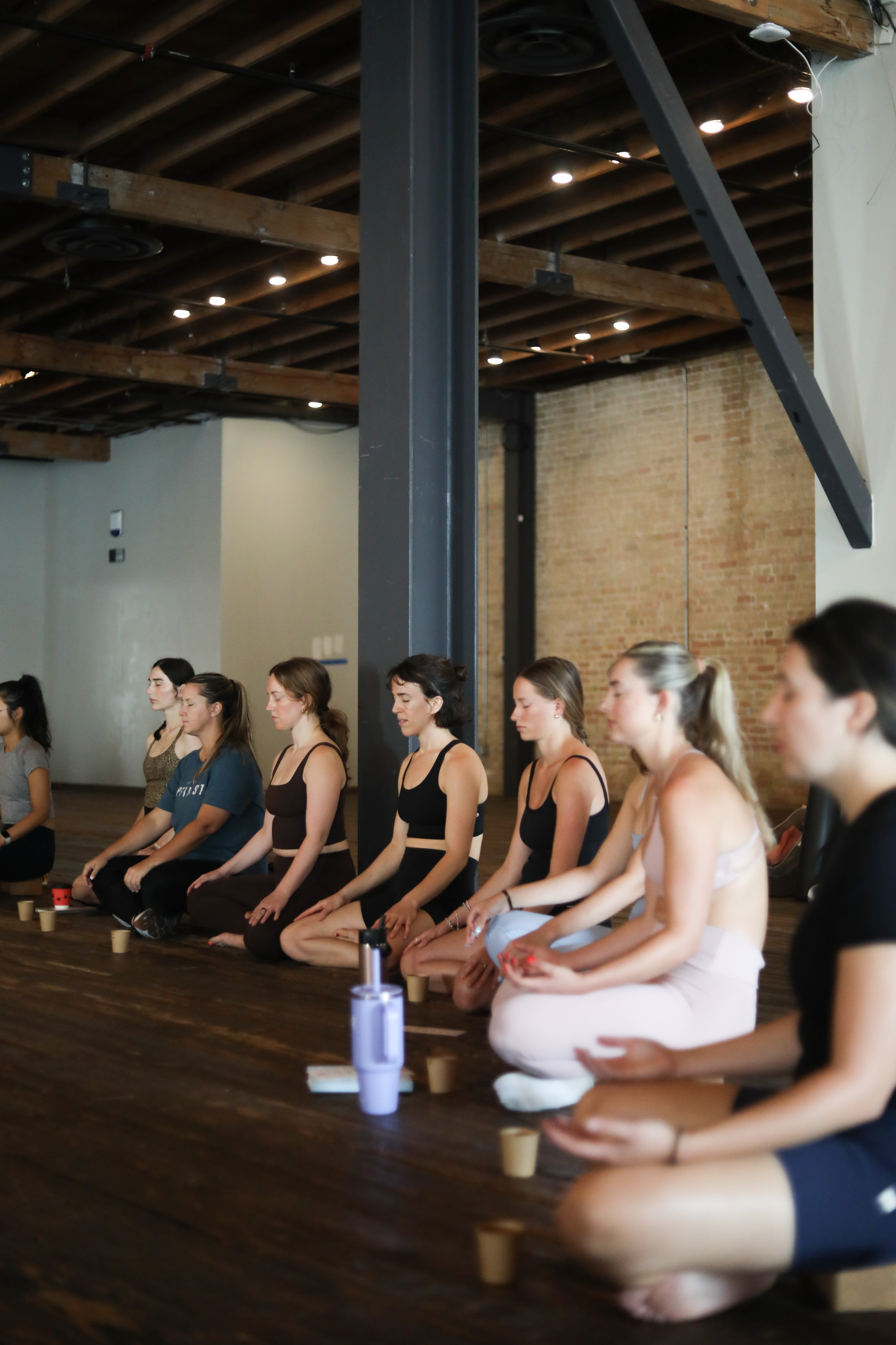 Corporate wellness workshop — group meditation session in an Austin, TX studio